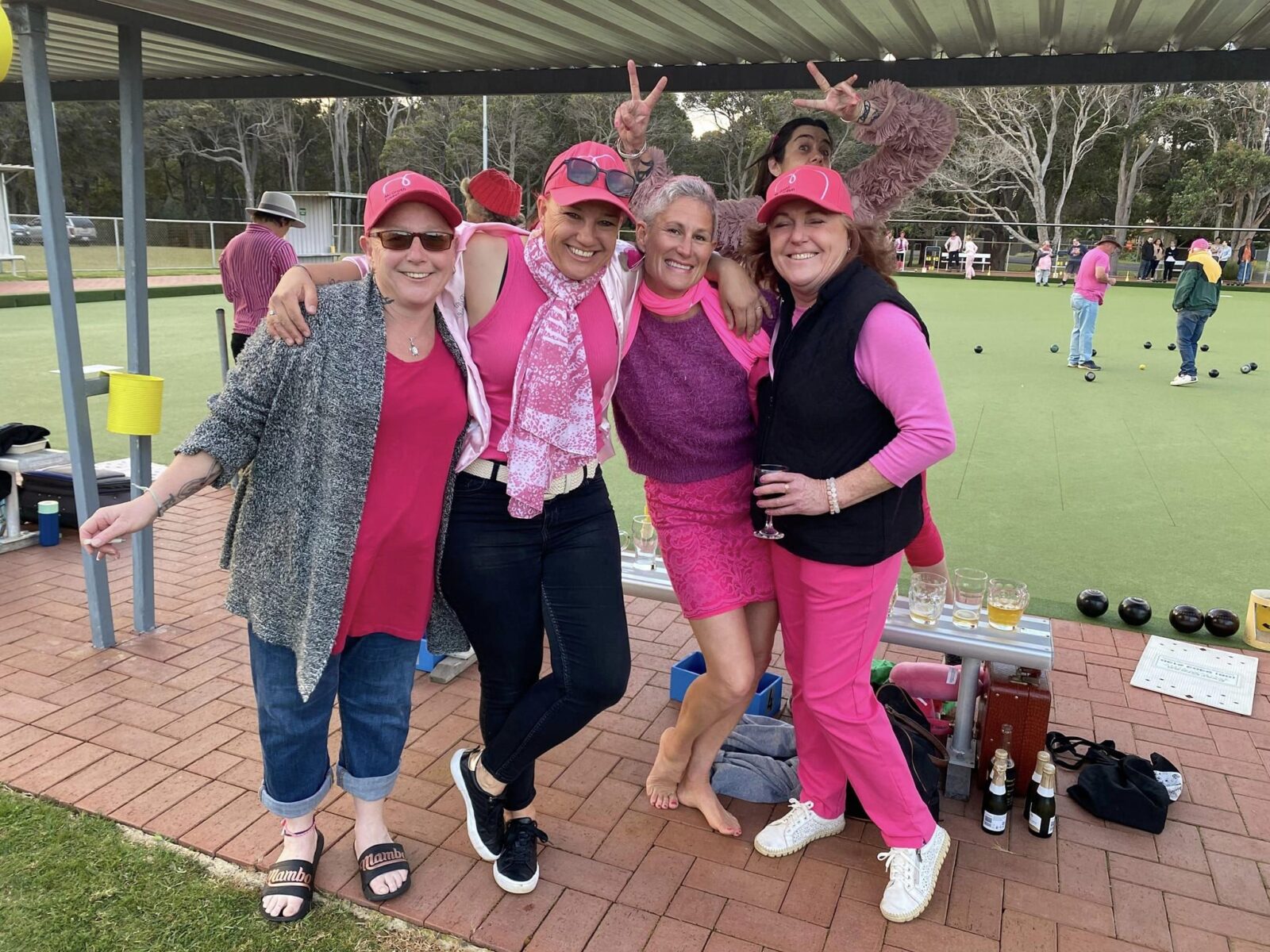 Group of fundraisers standing on bowling greens wearing pink for Pink Up Augusta.